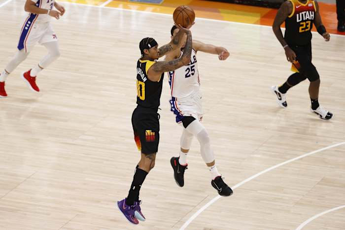 Ben Simmons (25) fouls Jordan Clarkson (00) as Clarkson shoots a 3-pointer